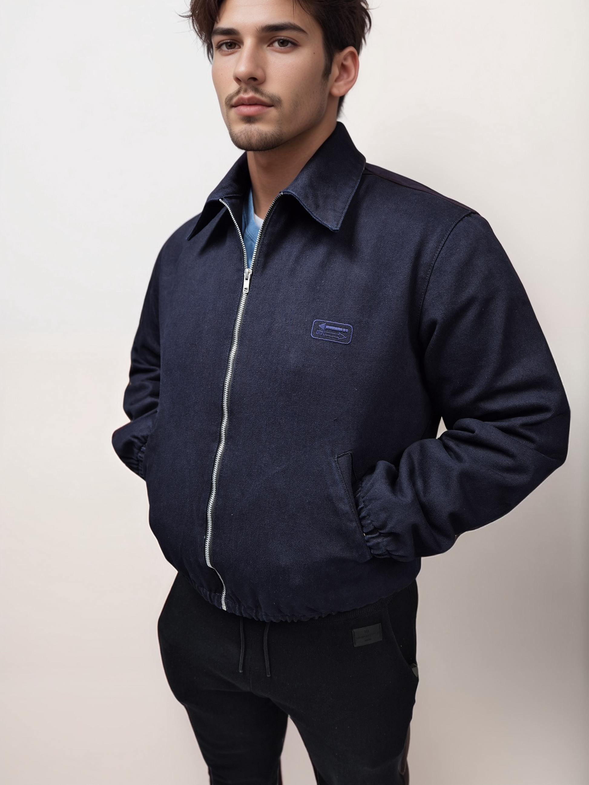 A male model wearing a navy No Limit London blue denim blouson bomber jacket with a zip closure, collar neckline, and side pockets. The jacket is fully lined with moleskin fabric.